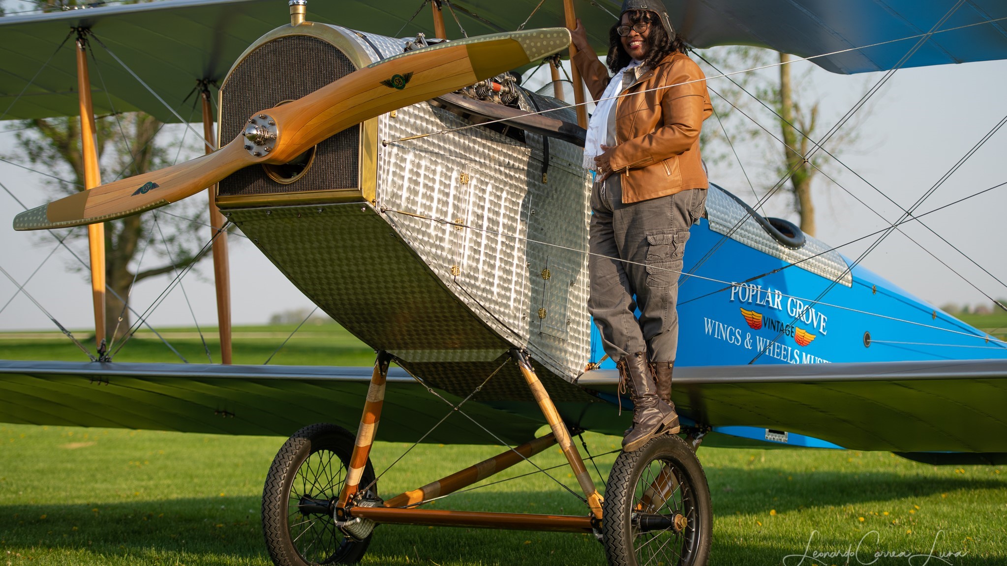 Woman standing on biplane